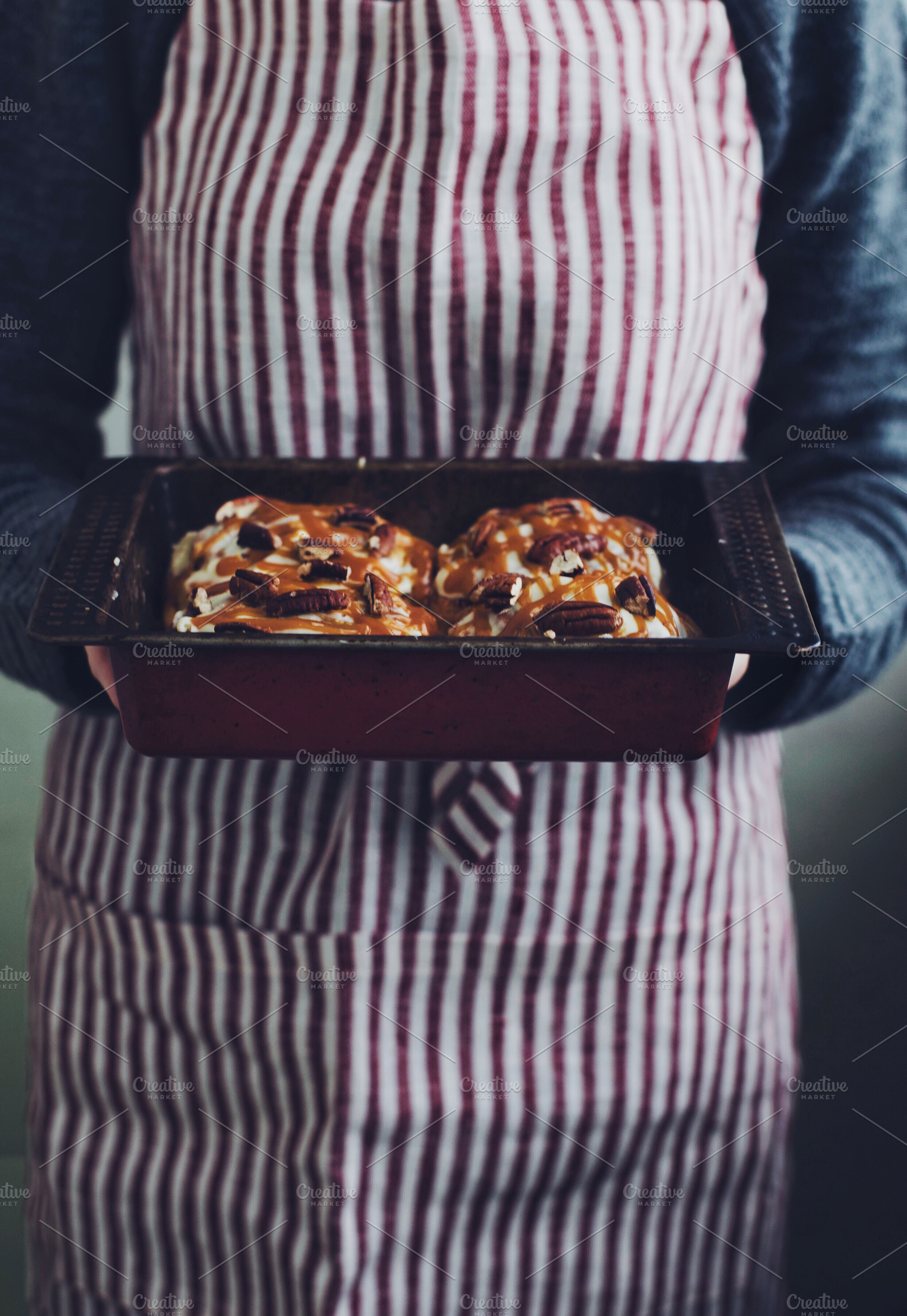 Woman holding cinnamon buns, a Food & Drink Photo by so_lizaveta