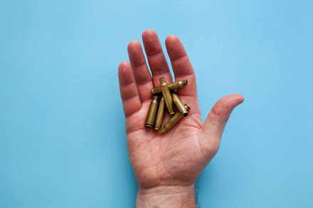 Used ammo on palm, an Industrial Photo by Photostock