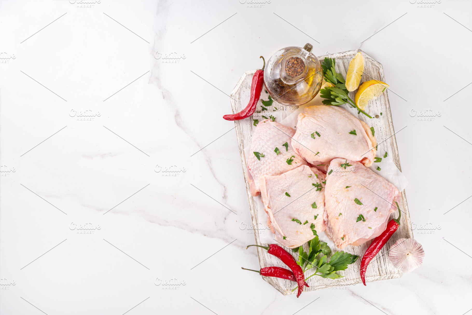 Fresh raw organic chicken thighs, with spices and condiments, a Food & Drink Photo by Rimma