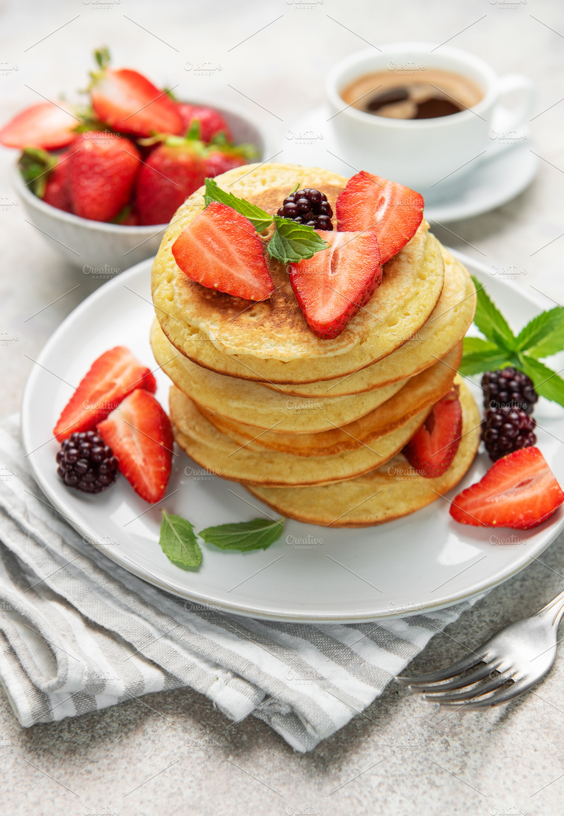 Stack of pancakes with strawberries, blackberries, and mint leav, a Food & Drink Photo by Olena Rudo