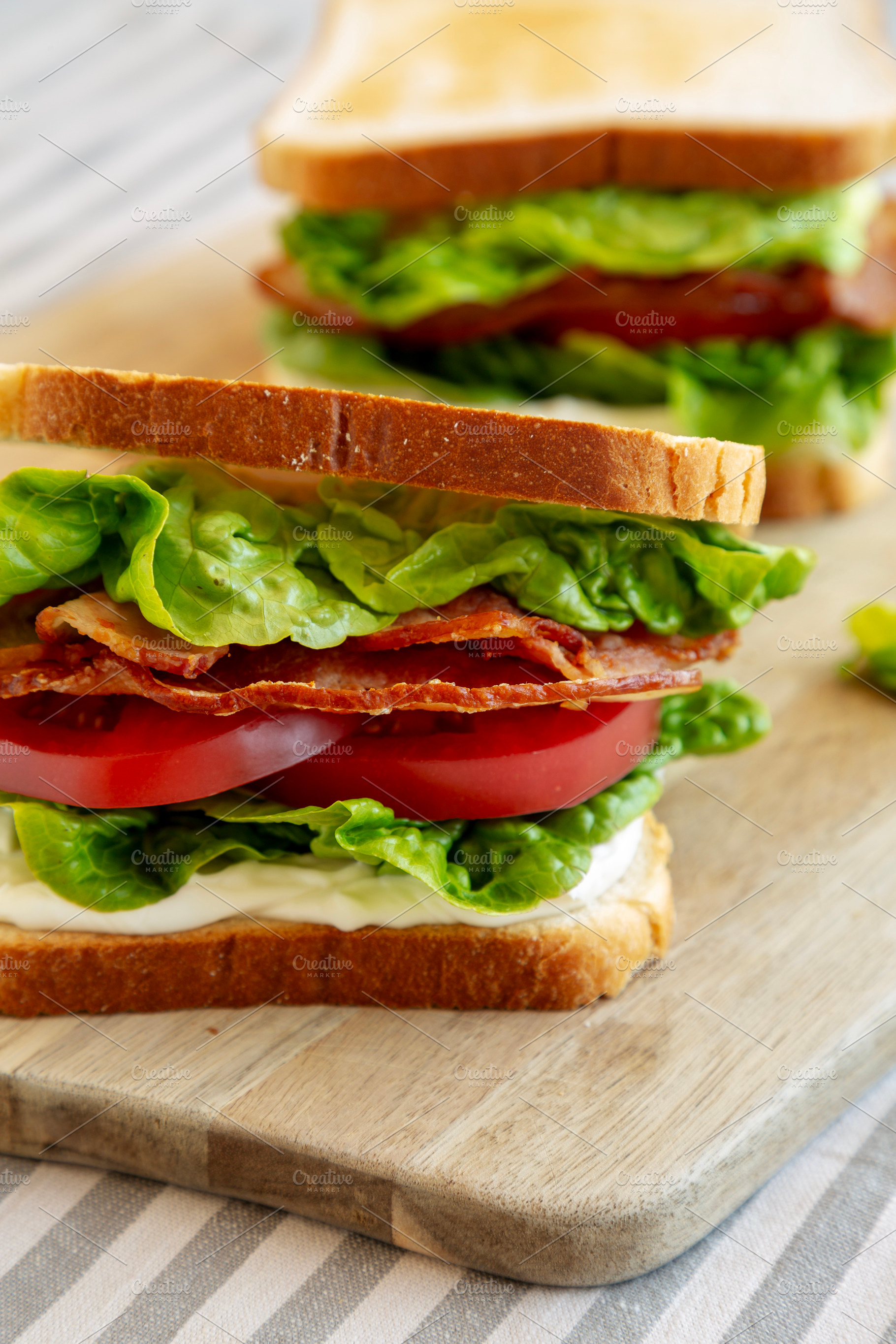 Homemade BLT (Bacon Lettuce Tomato) Sandwich with Mayo, side vie, a Food & Drink Photo by LiudmylaChuhunova