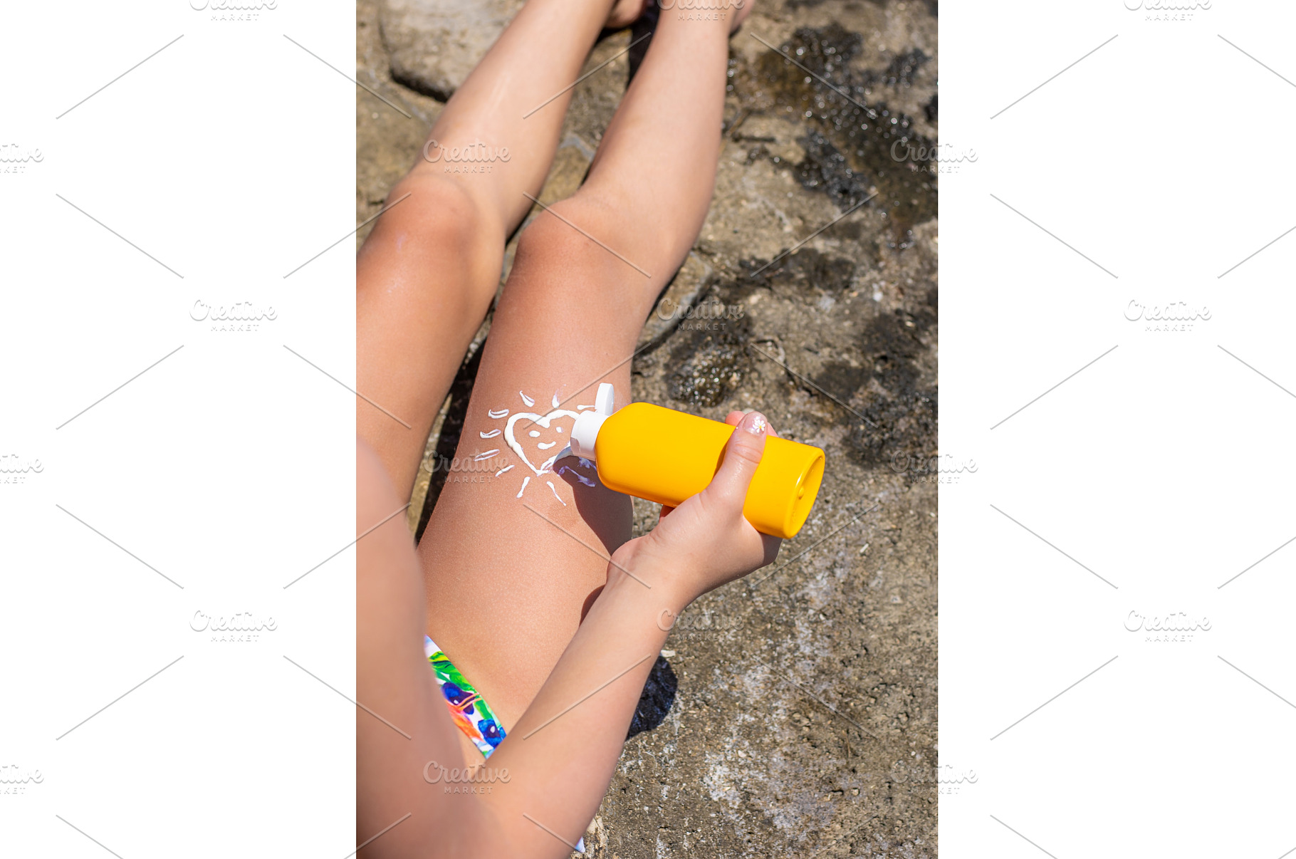 The child has sunscreen on his legs, a Person Photo by yanadjana