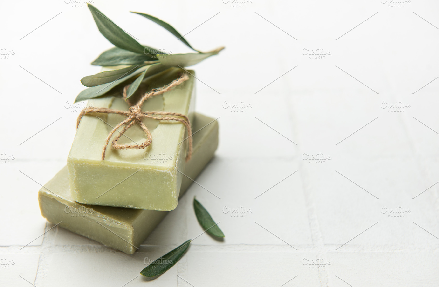 Natural olive soap bars decorated with olive tree branch on whit, a Beauty & Fashion Photo by Olena Rudo