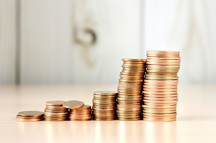 Stack of coins on wooden background, a Business Photo by AlyaAnd