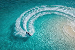 Person drives a jet ski in a circle, a Photo by Pavel_design
