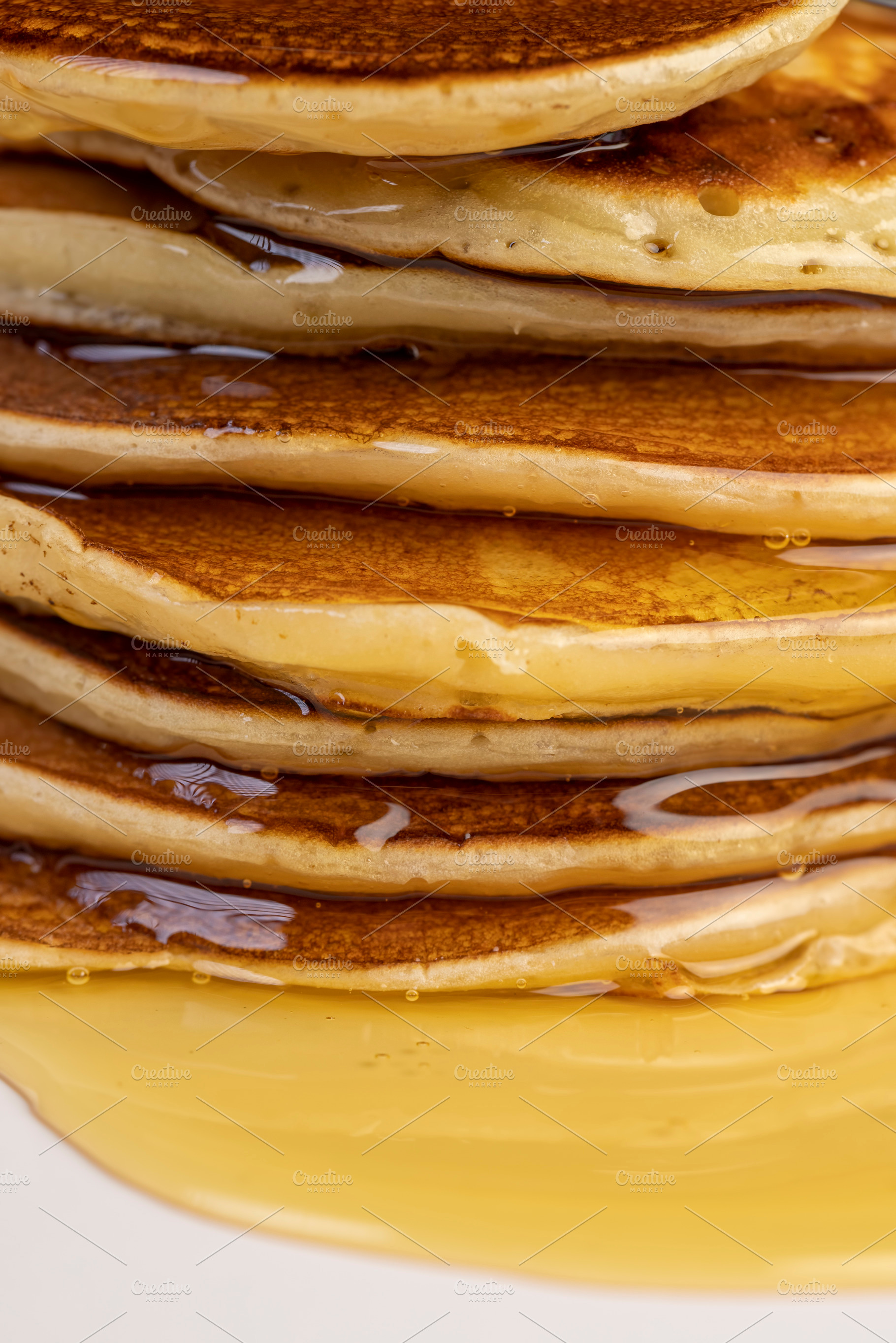 drizzled with honey, a large number of delicious pancakes stacked together on a, a Photo by rsoollAI
