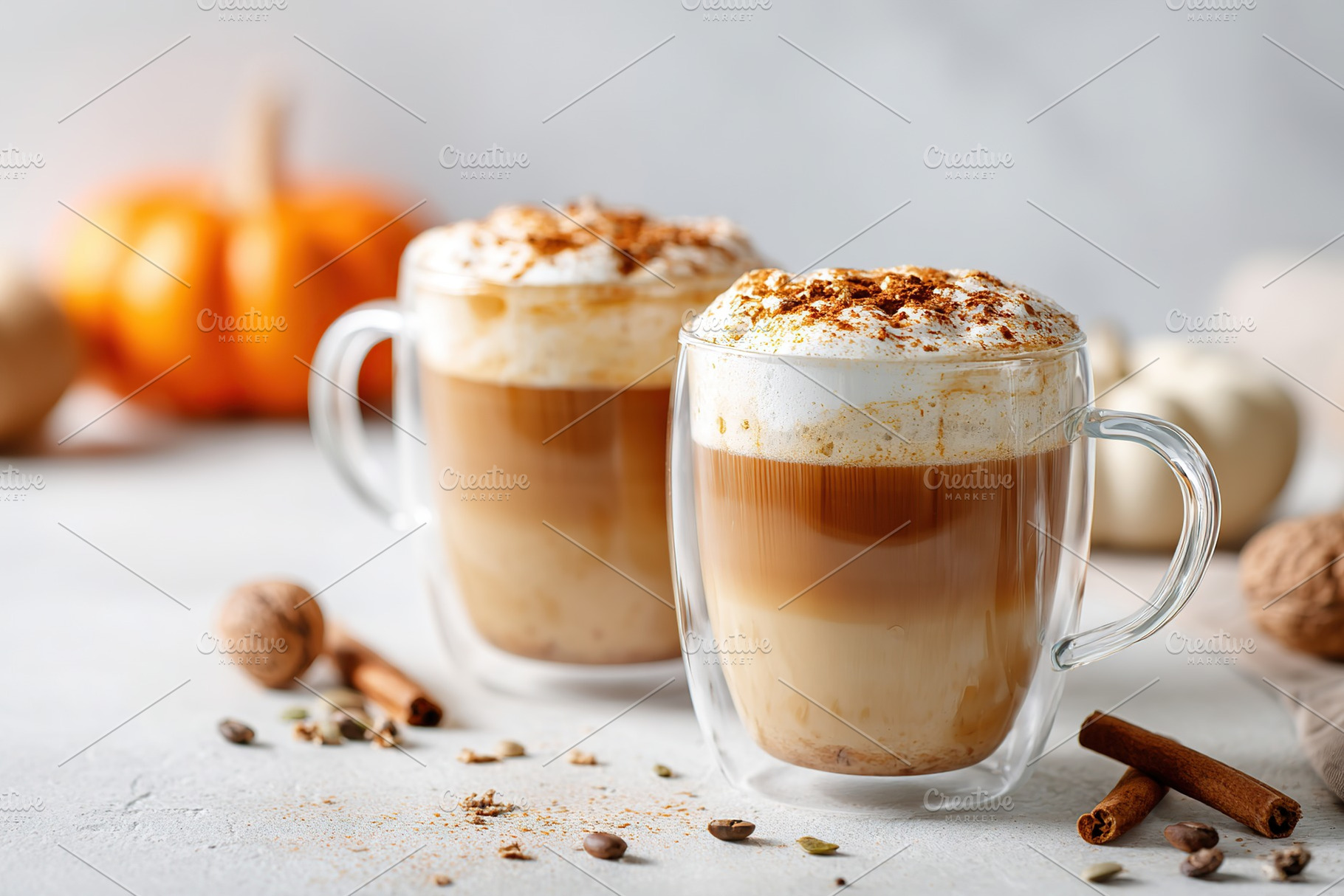 Warm spiced pumpkin beverages served in clear glass cups for autumn enjoyment, a Food & Drink Photo by AlyaAnd