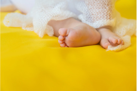 Baby feet on a yellow background, a Person Photo by yanadjana