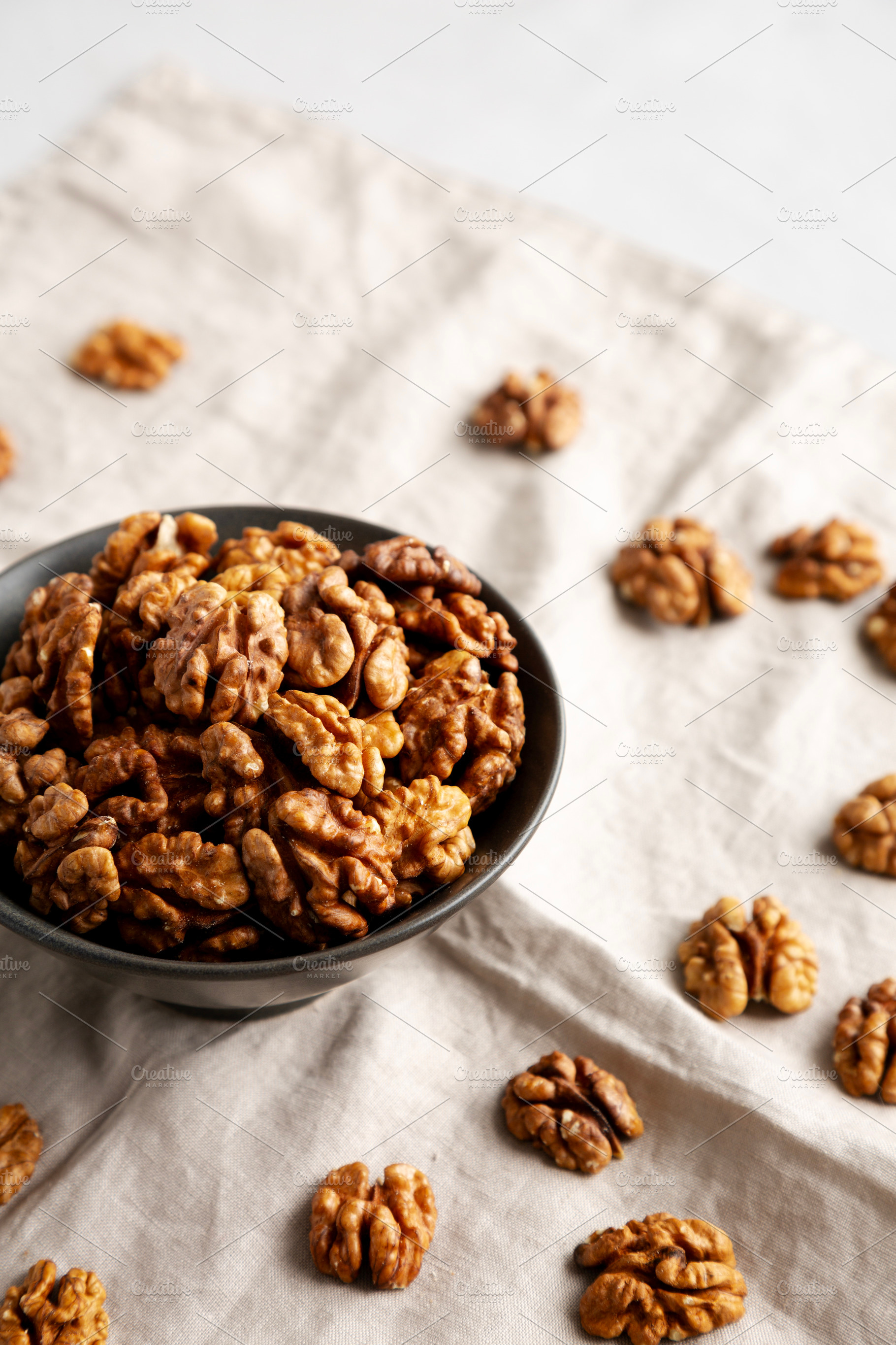 Raw Walnut Halfs in a Bowl, side view., a Food & Drink Photo by LiudmylaChuhunova