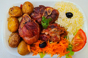 Hearty portuguese pork knuckle meal, a Food & Drink Photo by DanFLCreativo