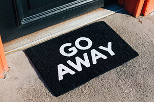 Welcome mat with a bold message placed at the entrance of a house, a Background Photo by AlyaAnd