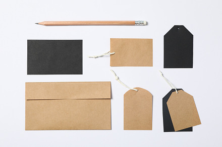 Flat lay composition with envelope, tags and pencil on white bac, a Business Photo by AtlasStudio PRO