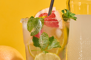 Glass with cold cocktail, citrus pieces inside, homemade drink, a Food & Drink Photo by ndanko