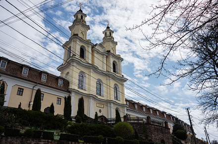 Historic church building against a bright sky in Buchach, Ukraine. Monastery of, a Photo by AS photostudio