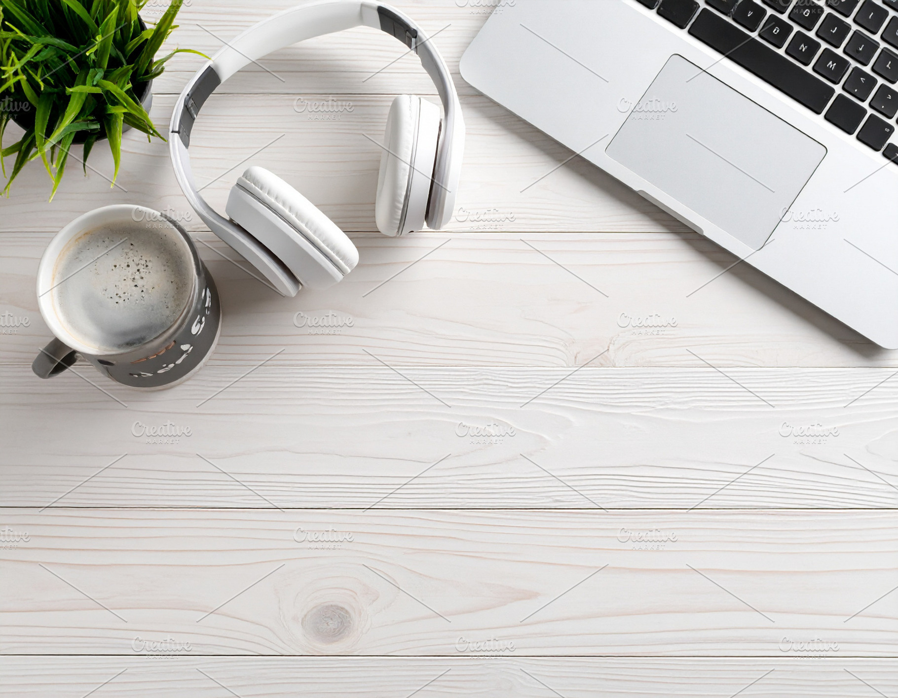 Closed laptop, a wireless headset, and a coffee mug, a Business Photo by DanFLCreativo