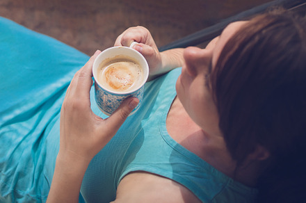 young caucasian happy woman drinking coffee in sunlight, top vie, a Person Photo by TanaCh
