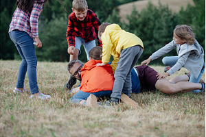 Young students playing with teacher, a Person Photo by HalfPoint