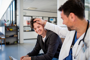 Teenage boy smiling talking with, a Sports & Recreation Photo by HalfPoint