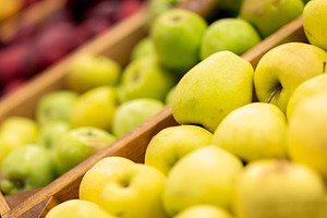 Showcase with various types of apples at supermarket, a Photo by Prostock-Studio