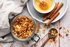 Granola in jar with honey and cinnamon, a Food & Drink Photo by Olena Rudo