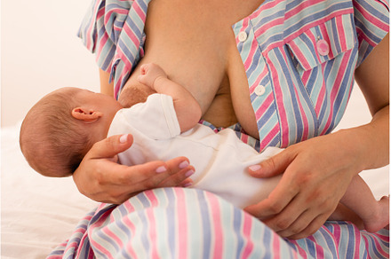 The mom is breastfeeding her newborn, a Health & Medical Photo by oksix