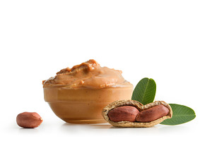 Peanut butter in a glass bowl isolated on white background, a Food & Drink Photo by Davizro's Market