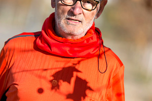 Senior man in red sportswear under autumn tree shadows, a Sports & Recreation Photo by RF Images