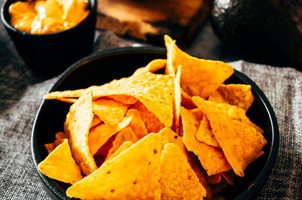 Mexican nachos with guacamole, cheddar cheese and chili.