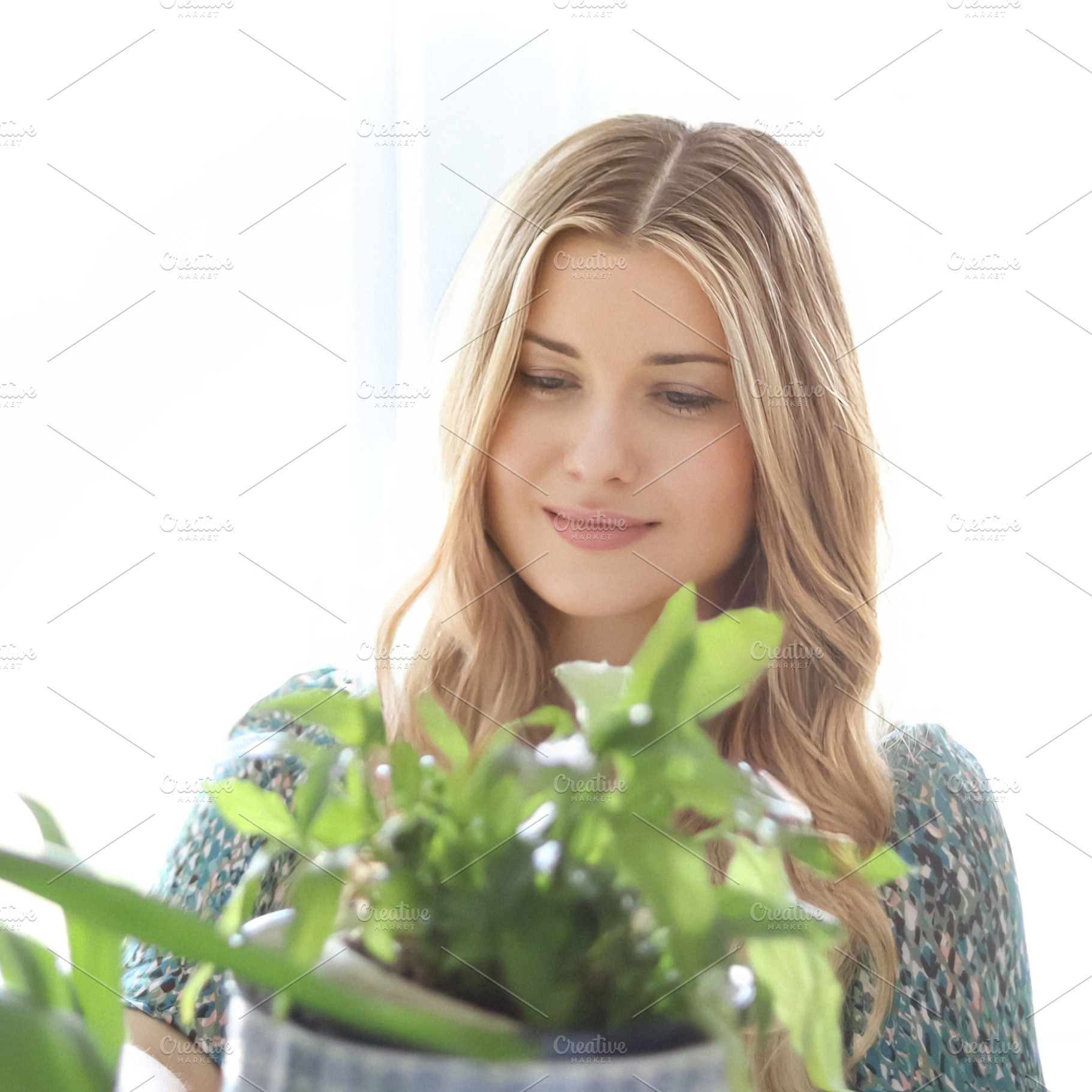 Blonde woman in a green dress looking at a houseplant with soft, a Person Photo by Studio ANNA