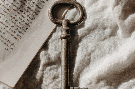 Vintage key on white linen, a Photo by Virgo Studio