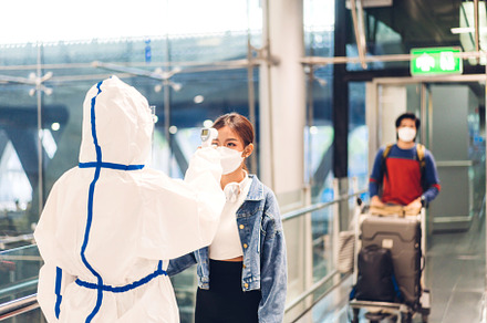 Doctor woman use infrared forehead thermometer for check body te, a Person Photo by Art_Photo