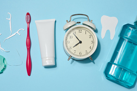 Set of oral hygiene products and items including red toothbrush,