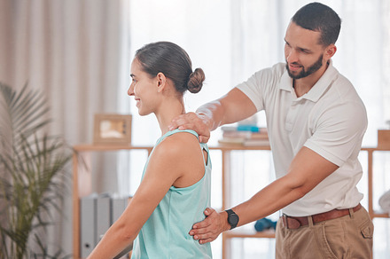 Chiropractor, woman and massage for physical therapy, health and posture at wellness clinic. Doctor, girl and spine alignment for medical, chiropractic or rehabilitation with help in physiotherapy, a Photo by Peopleimages.com