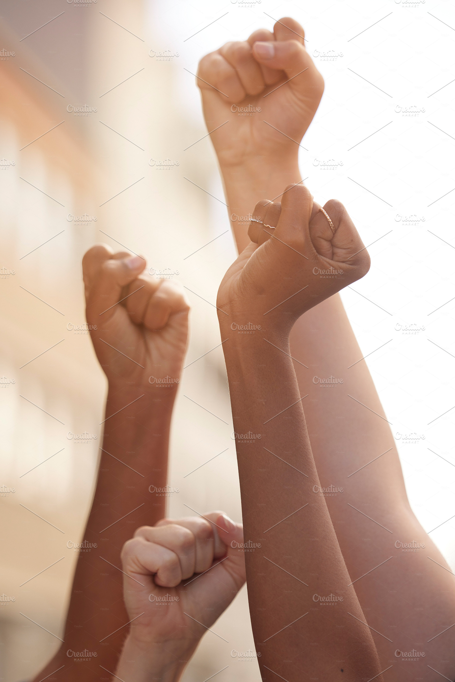 Hands fist and justice of power by people in public protest for freedom, equality and change in a street. Community, action and government rally by man and woman in solidarity for society democracy, a Photo by Peopleimages.com