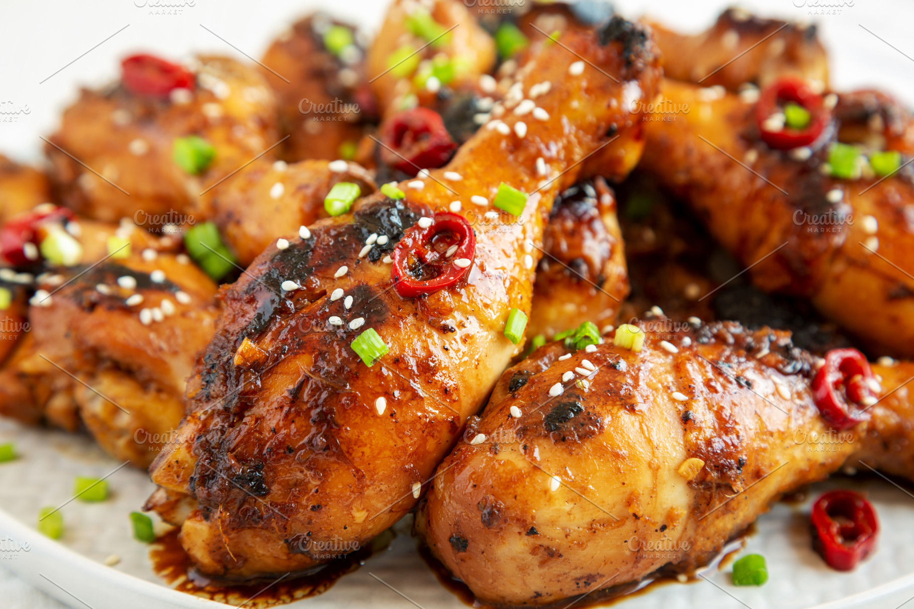Homemade Easy Sticky Chicken Drumsticks on a Plate on a white wo, a Food & Drink Photo by LiudmylaChuhunova
