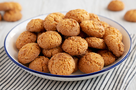 Homemade Sweet and Crunchy Amaretti on a Plate, side view. Close, a Food & Drink Photo by LiudmylaChuhunova