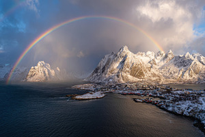Rainbow over snowy mountains and sea, a Photo by Beautiful things