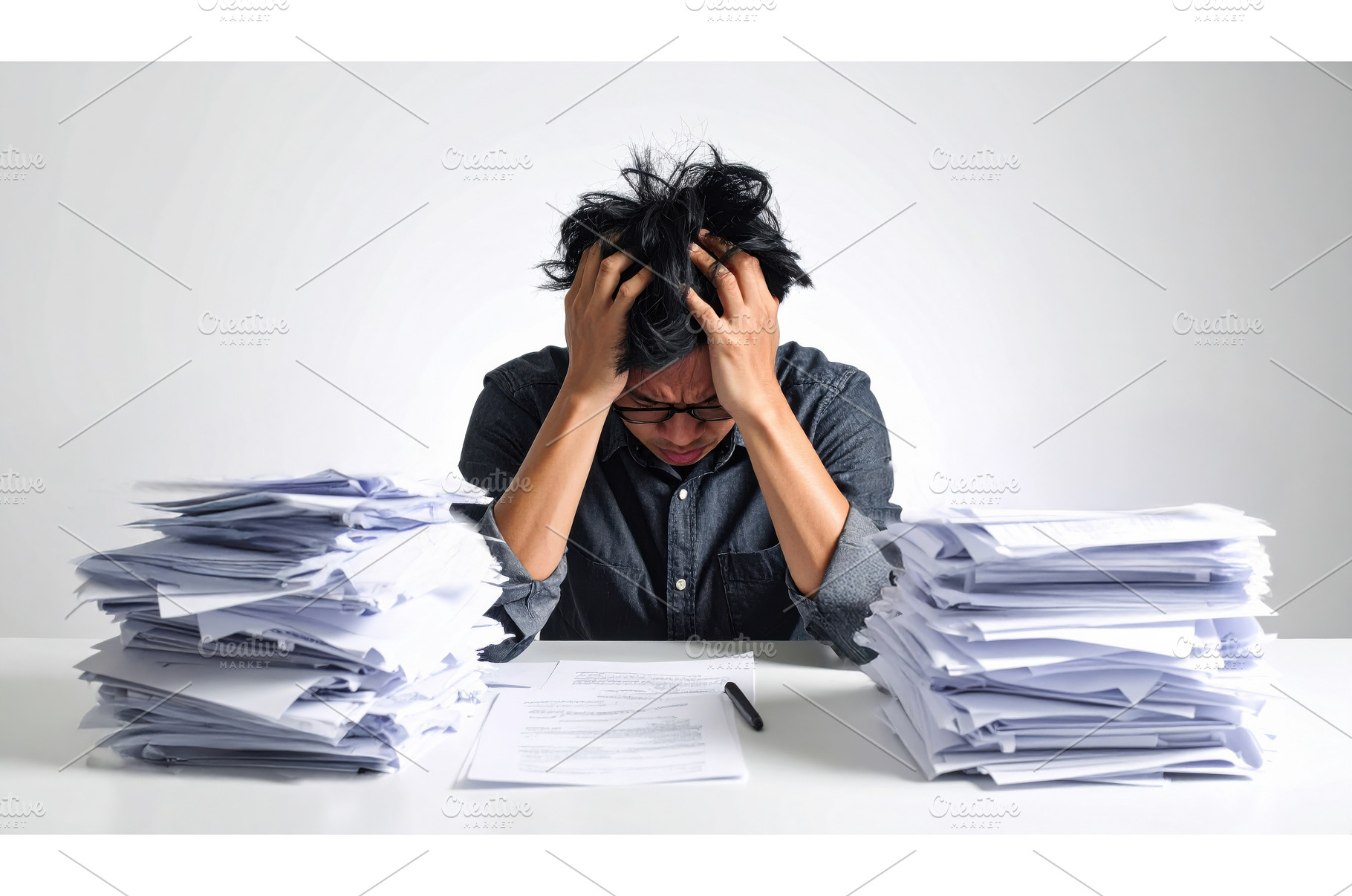 Overworked man overwhelmed by paper, a Business Photo by Igor Tichonow