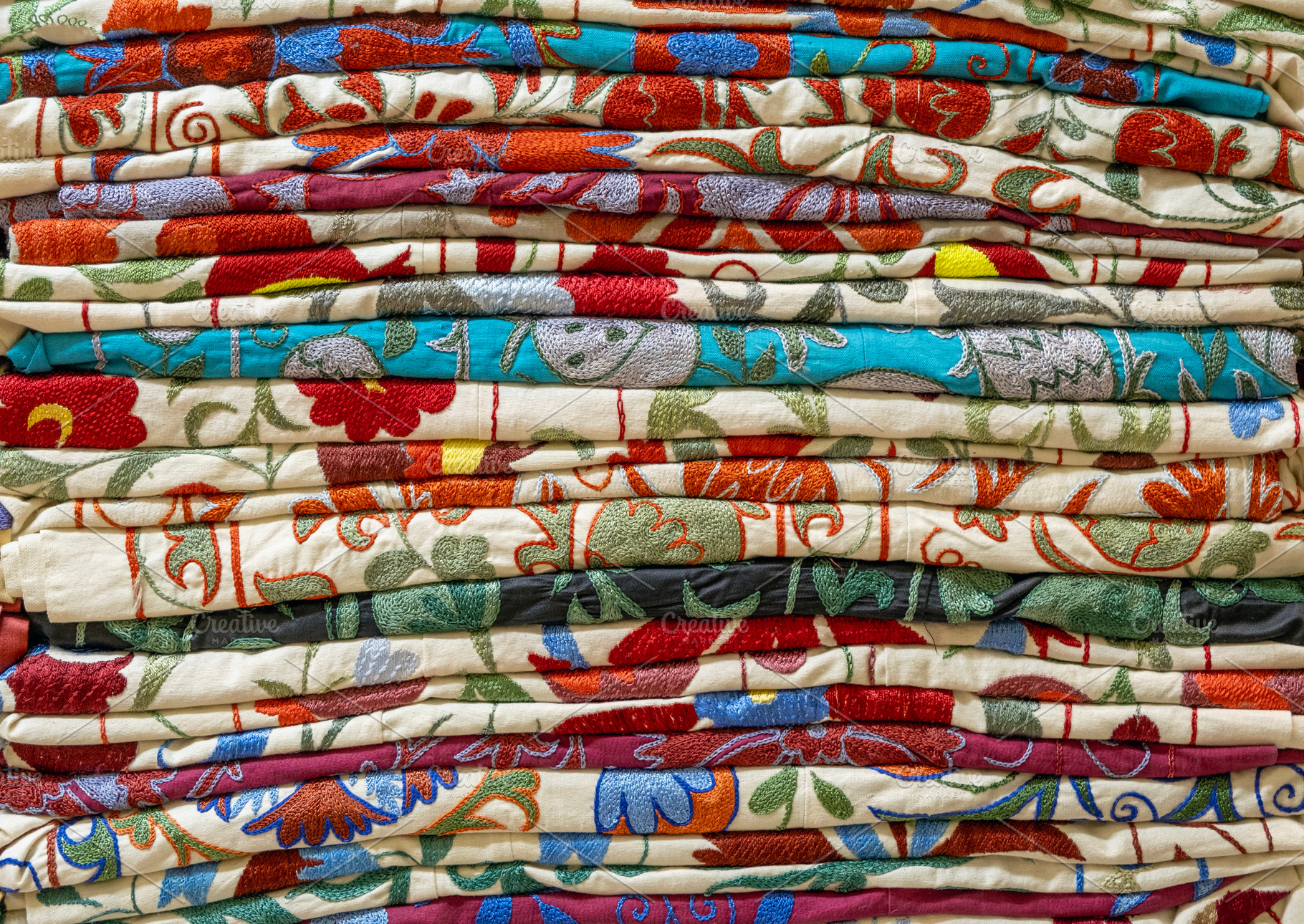 Colorful stacked woven fabric, a Background Photo by BOOCYS