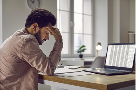 Tired, stressed man sitting at his, a Business Photo by StudioRomantic