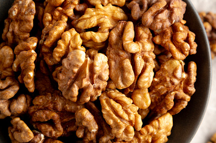 Raw Walnut Halfs in a Bowl, top view. Flat lay, overhead. Close-