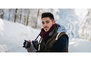 Male photographer holding camera, a Beauty & Fashion Photo by HalfPoint