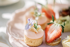 Afternoon tea party setting featuring a close up of dainty petit, a Photo by Studio ANNA