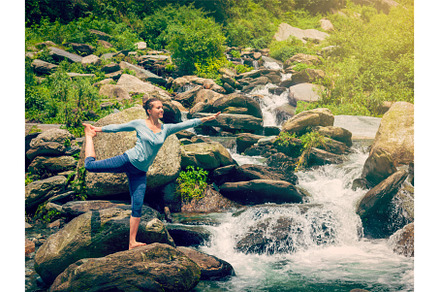 Woman doing yoga asana Natarajasana, a Person Photo by f9photos