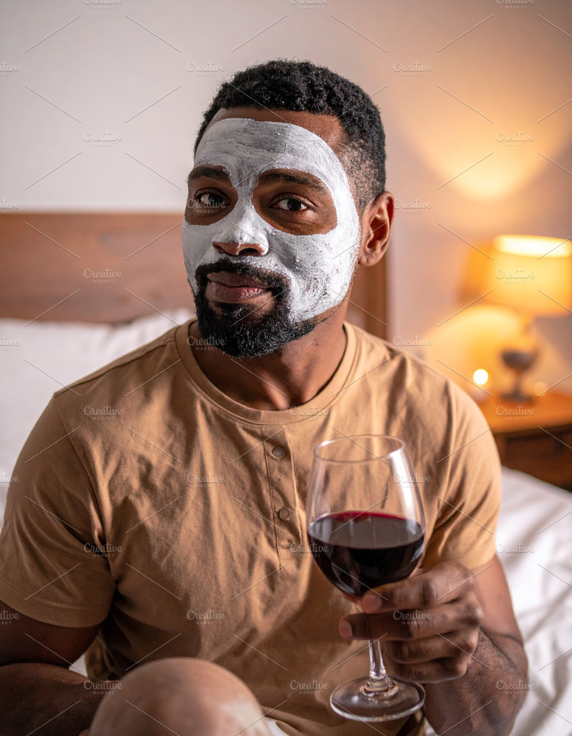 Man with her face covered by a white facial mask while holding a, a Health & Medical Photo by DanFLCreativo