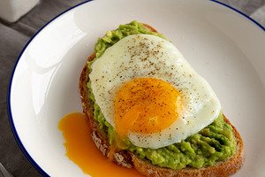 Homemade Avocado Toast with Egg on a Plate, side view. Close-up., a Food & Drink Photo by LiudmylaChuhunova