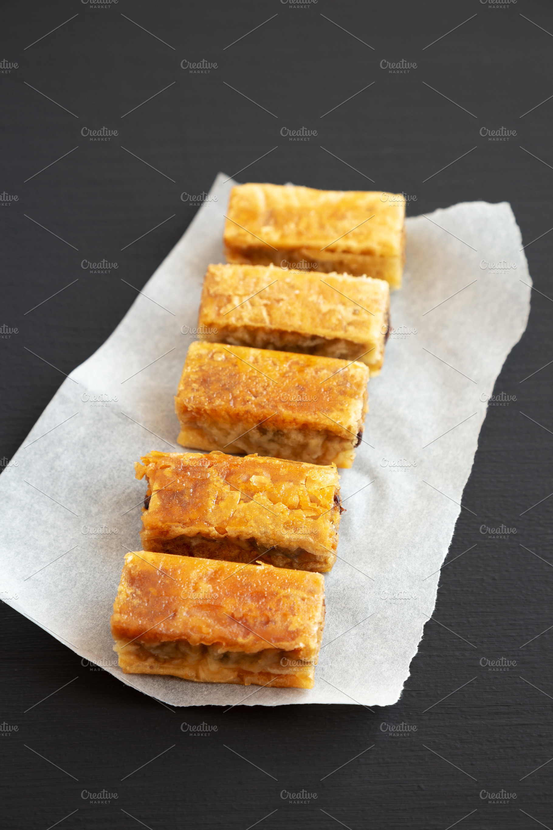 Homemade Baklavas with Honey, Chocolate and Almond on a black ba, a Food & Drink Photo by LiudmylaChuhunova