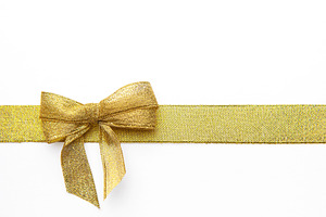 Gold ribbon bow creating a festive background decoration, a Holiday Photo by Olena Rudo