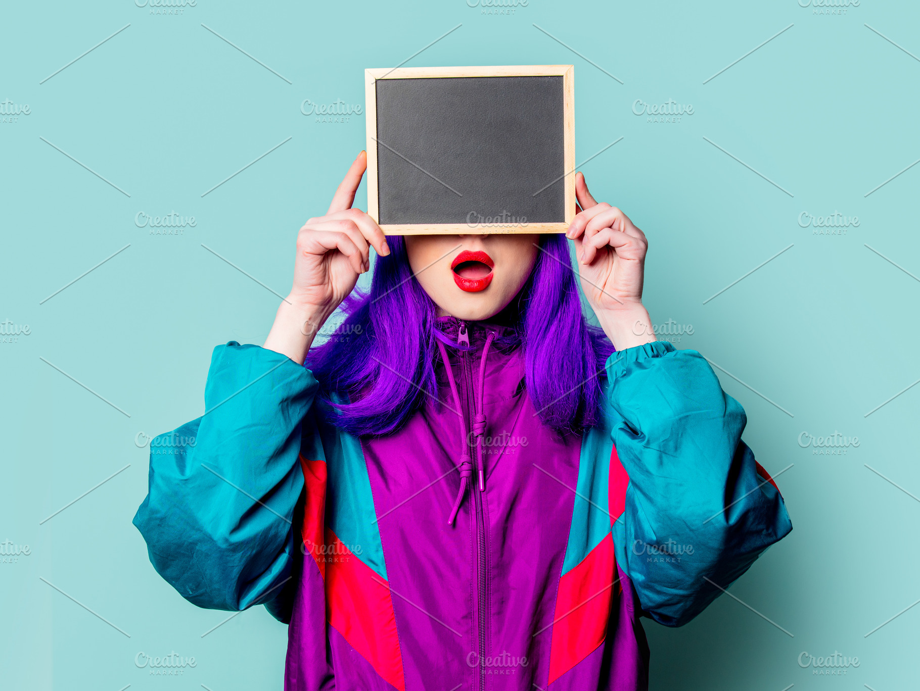 Stylish white girl with purple hair and 80s tracksuit hold board, a Person Photo by Masson Simon