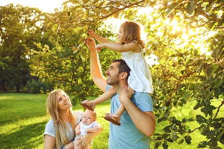 Happy young family with children in featuring family, happy, and nature, a Person Photo by StudioRomantic